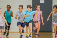 kids running in a race in a school gym